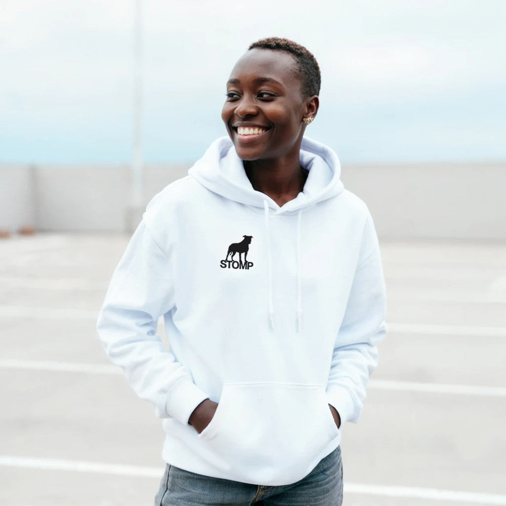 Person wearing a white hoodie with a logo, standing outdoors.