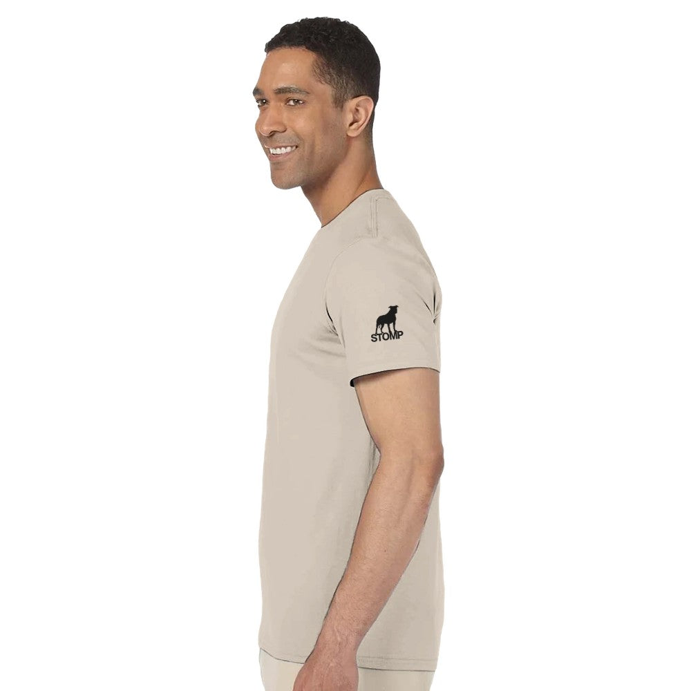 Man wearing a beige t-shirt with a logo on the sleeve against a white background