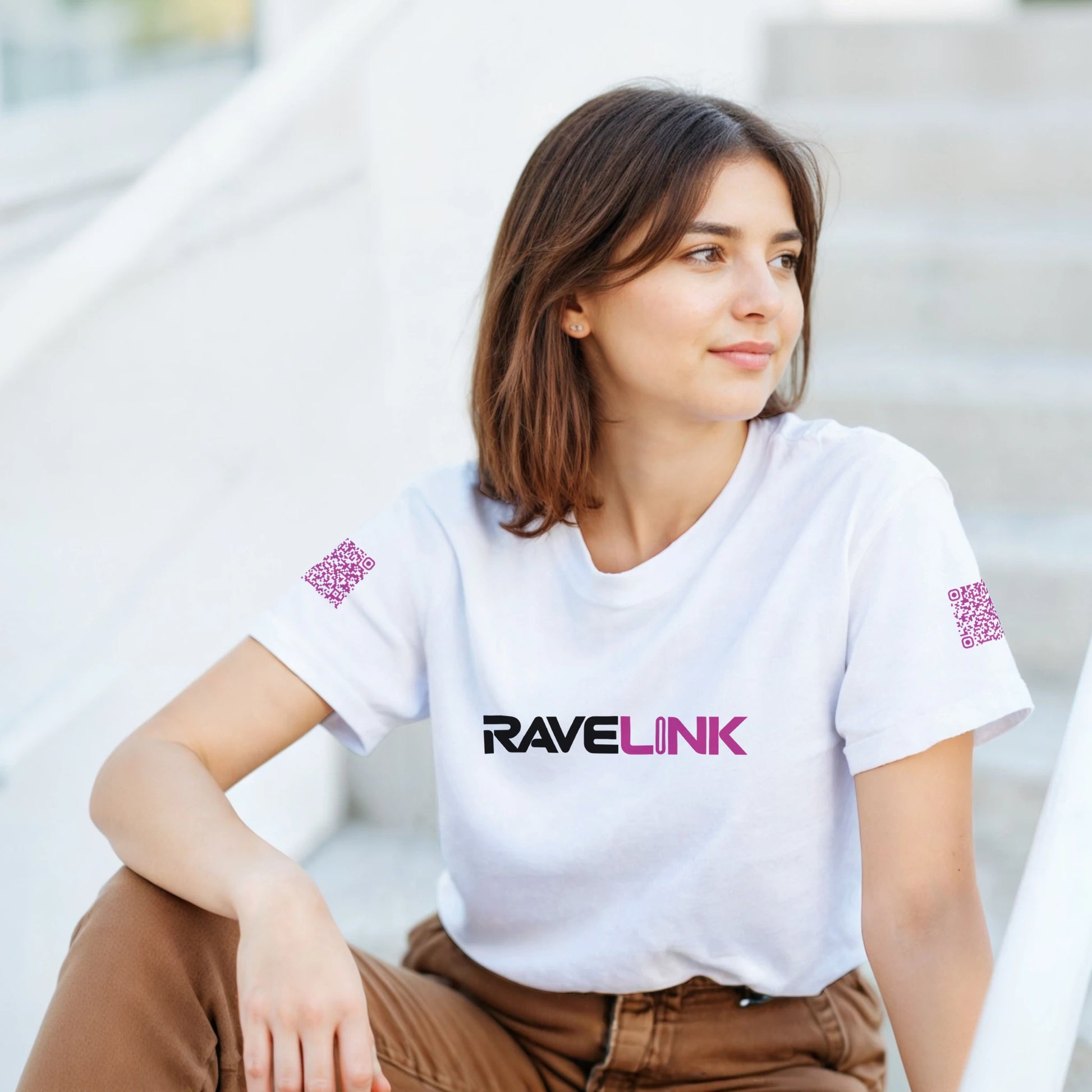 a white rave t-shirt with a pink font that is a custom Tiktok handle - custom QR Codes on each arm - RaveLink